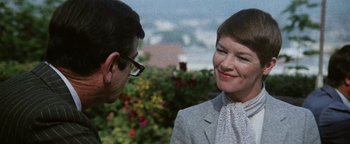 Movie still from “Hopscotch” (1980), directed by Ronald Neame – A man and a woman talking to each other outside; Close Up shot, Over the shoulder angle