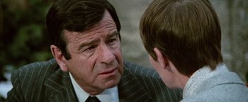 Movie still from “Hopscotch” (1980), directed by Ronald Neame – An older man and a young boy talking to each other; Close Up shot, Over the shoulder angle