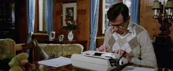 Movie still from “Hopscotch” (1980), directed by Ronald Neame – A man sitting in front of an old fashioned typewriter; Medium shot, Low angle
