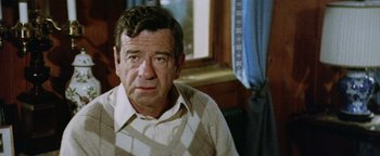 Movie still from “Hopscotch” (1980), directed by Ronald Neame – An older man sitting in front of a window; Close Up shot, High angle