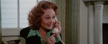Movie still from “Hopscotch” (1980), directed by Ronald Neame – An older woman talking on a phone while wearing a ring; Close Up shot, High angle