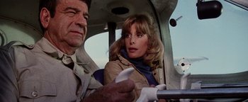 Movie still from “Hopscotch” (1980), directed by Ronald Neame – A man and a woman in the cockpit of an airplane; Medium shot, Low angle