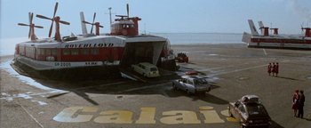 Movie still from “Hopscotch” (1980), directed by Ronald Neame – A car being unloaded from a boat on the beach; Extreme Wide shot, Low angle