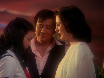 Movie still from “House” (1977), directed by Nobuhiko Ôbayashi – A man and two women standing next to each other; Medium shot, Low angle