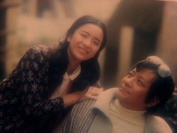 Movie still from “House” (1977), directed by Nobuhiko Ôbayashi – An older man and a younger woman posing for a picture; Close Up shot, Low angle
