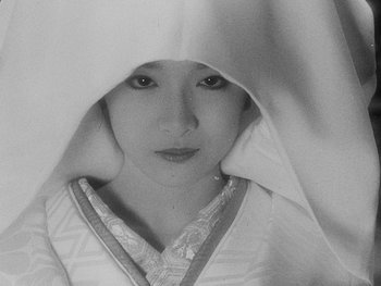 Movie still from “House” (1977), directed by Nobuhiko Ôbayashi – A young woman in a kimono with a towel over her head; Extreme Close Up shot, High angle