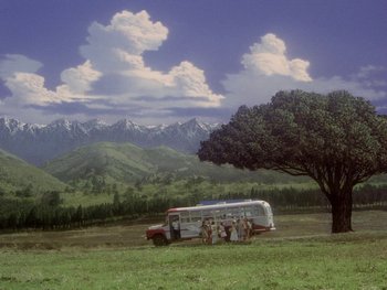 Movie still from “House” (1977), directed by Nobuhiko Ôbayashi – A group of people standing under a tree near a bus; Extreme Wide shot, Low angle