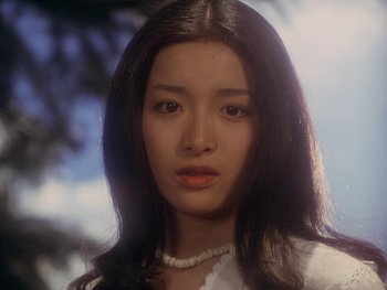 Movie still from “House” (1977), directed by Nobuhiko Ôbayashi – A woman with long black hair wearing a white shirt; Close Up shot, Low angle