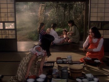 Movie still from “House” (1977), directed by Nobuhiko Ôbayashi – A group of people sitting around a room with bowls; Wide shot, High angle