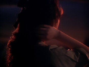 Movie still from “House” (1977), directed by Nobuhiko Ôbayashi – A woman with her hand over her face; Close Up shot, Over the shoulder angle