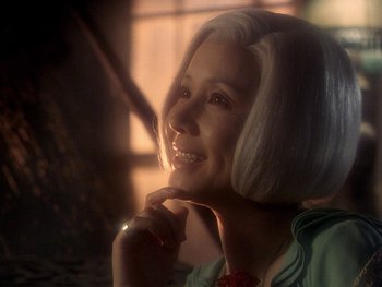 Movie still from “House” (1977), directed by Nobuhiko Ôbayashi – A person sitting in front of a window; Close Up shot, Over the shoulder angle