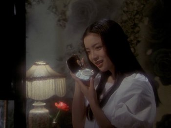 Movie still from “House” (1977), directed by Nobuhiko Ôbayashi – A young woman holding a cell phone in front of her face; Close Up shot, High angle