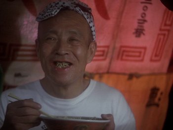 Movie still from “House” (1977), directed by Nobuhiko Ôbayashi – An older man eating a bowl of noodles; Close Up shot, Low angle