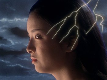 Movie still from “House” (1977), directed by Nobuhiko Ôbayashi – A woman with lightning in her hair looking into the distance; Close Up shot, Low angle