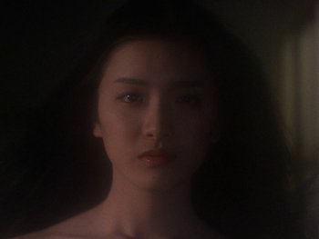 Movie still from “House” (1977), directed by Nobuhiko Ôbayashi – A young woman with long black hair is looking at the camera; Close Up shot, Low angle