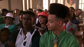 Movie still from “House Party 2” (1991), directed by Doug McHenry – A group of young men sitting in a room; Close Up shot, Low angle