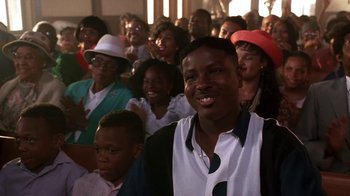 Movie still from “House Party 2” (1991), directed by Doug McHenry – A group of people sitting in front of each other; Close Up shot, Low angle