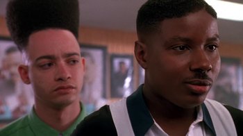 Movie still from “House Party 2” (1991), directed by Doug McHenry – Two young men standing next to each other in a room; Close Up shot, Low angle