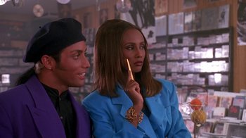 Movie still from “House Party 2” (1991), directed by Doug McHenry – A man and a woman standing next to each other; Close Up shot, Over the shoulder angle