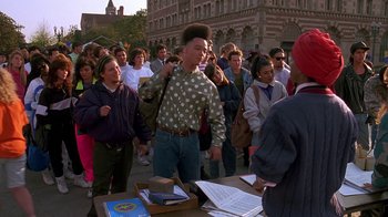 Movie still from “House Party 2” (1991), directed by Doug McHenry – A crowd of people standing around a table; Medium shot, High angle