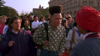 Movie still from “House Party 2” (1991), directed by Doug McHenry – A group of people walking down a street; Medium shot, Low angle