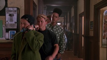 Movie still from “House Party 2” (1991), directed by Doug McHenry – A group of young men walking down a hall way; Medium shot, Low angle