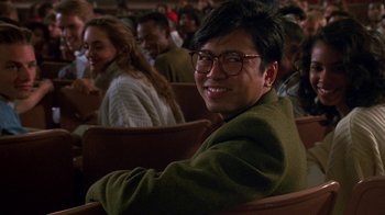 Movie still from “House Party 2” (1991), directed by Doug McHenry – A man sitting in front of a group of people; Close Up shot, Low angle