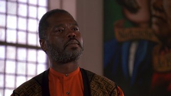 Movie still from “House Party 2” (1991), directed by Doug McHenry – An older black man wearing an orange shirt; Close Up shot, Low angle