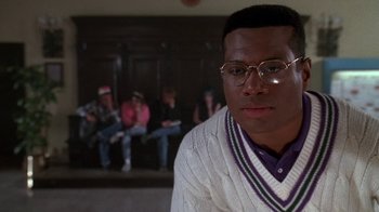 Movie still from “House Party 2” (1991), directed by Doug McHenry – A man in a white sweater and glasses; Close Up shot, Low angle