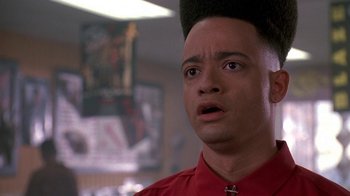 Movie still from “House Party 2” (1991), directed by Doug McHenry – A person wearing a red shirt; Close Up shot, Low angle