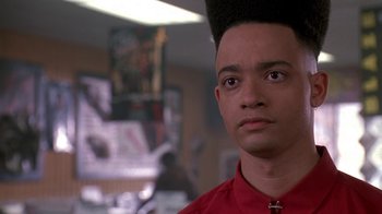 Movie still from “House Party 2” (1991), directed by Doug McHenry – A person wearing a red shirt; Close Up shot, Low angle