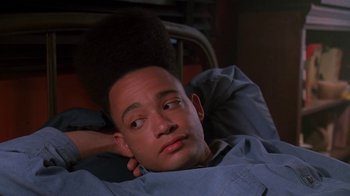 Movie still from “House Party 2” (1991), directed by Doug McHenry – A man laying in a bed with his hand on his head; Close Up shot, Low angle