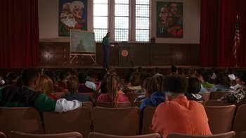 Movie still from “House Party 2” (1991), directed by Doug McHenry – A group of people sitting in front of an audience; Wide shot, High angle