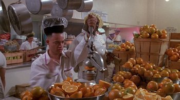 Movie still from “House Party 2” (1991), directed by Doug McHenry – Two men in a kitchen preparing oranges for sale; Medium shot, Low angle