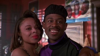 Movie still from “House Party 2” (1991), directed by Doug McHenry – A man and a woman posing for a picture; Close Up shot, Low angle