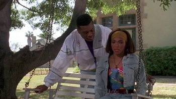 Movie still from “House Party 2” (1991), directed by Doug McHenry – A man and a woman sitting on a swing; Medium shot, Over the shoulder angle