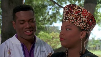 Movie still from “House Party 2” (1991), directed by Doug McHenry – A man standing next to a woman wearing a hat; Close Up shot, Over the shoulder angle