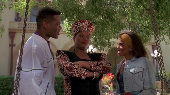 Movie still from “House Party 2” (1991), directed by Doug McHenry – A group of people standing next to each other in front of a tree; Medium shot, Low angle
