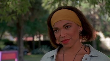 Movie still from “House Party 2” (1991), directed by Doug McHenry – A person wearing a head band; Close Up shot, Over the shoulder angle