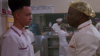 Movie still from “House Party 2” (1991), directed by Doug McHenry – Two people in a kitchen talking to each other; Close Up shot, Over the shoulder angle