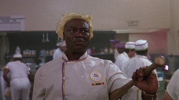 Movie still from “House Party 2” (1991), directed by Doug McHenry – A man in a chef's outfit is looking at the camera; Close Up shot, Low angle