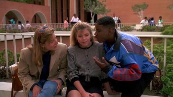Movie still from “House Party 2” (1991), directed by Doug McHenry – A group of young people sitting on a bench talking to each other; Medium shot, Over the shoulder angle