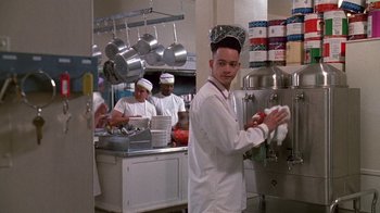 Movie still from “House Party 2” (1991), directed by Doug McHenry – A group of people in a kitchen preparing food; Medium shot, Low angle