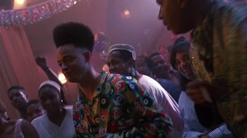 Movie still from “House Party 2” (1991), directed by Doug McHenry – A group of people in a room with lights on; Medium shot, Low angle