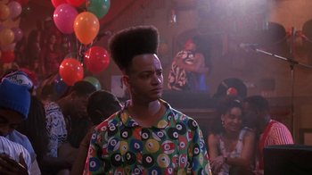 Movie still from “House Party 2” (1991), directed by Doug McHenry – A man in a colorful shirt with a bunch of balloons in the background; Medium shot, Low angle