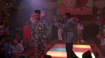 Movie still from “House Party 2” (1991), directed by Doug McHenry – A man in pajamas standing in front of a group of people; Medium shot, High angle