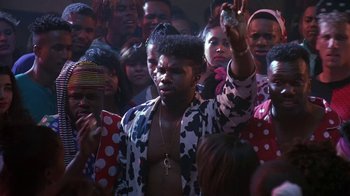 Movie still from “House Party 2” (1991), directed by Doug McHenry – A group of people gathered together in a room; Medium shot, Low angle