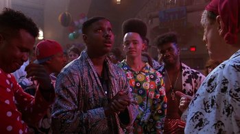 Movie still from “House Party 2” (1991), directed by Doug McHenry – A group of young men standing in front of a crowd; Medium shot, Low angle