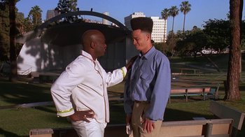 Movie still from “House Party 2” (1991), directed by Doug McHenry – A couple of men standing next to each other; Medium shot, Low angle