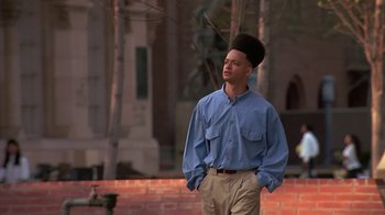 Movie still from “House Party 2” (1991), directed by Doug McHenry – A man standing in front of a brick wall; Medium shot, Low angle